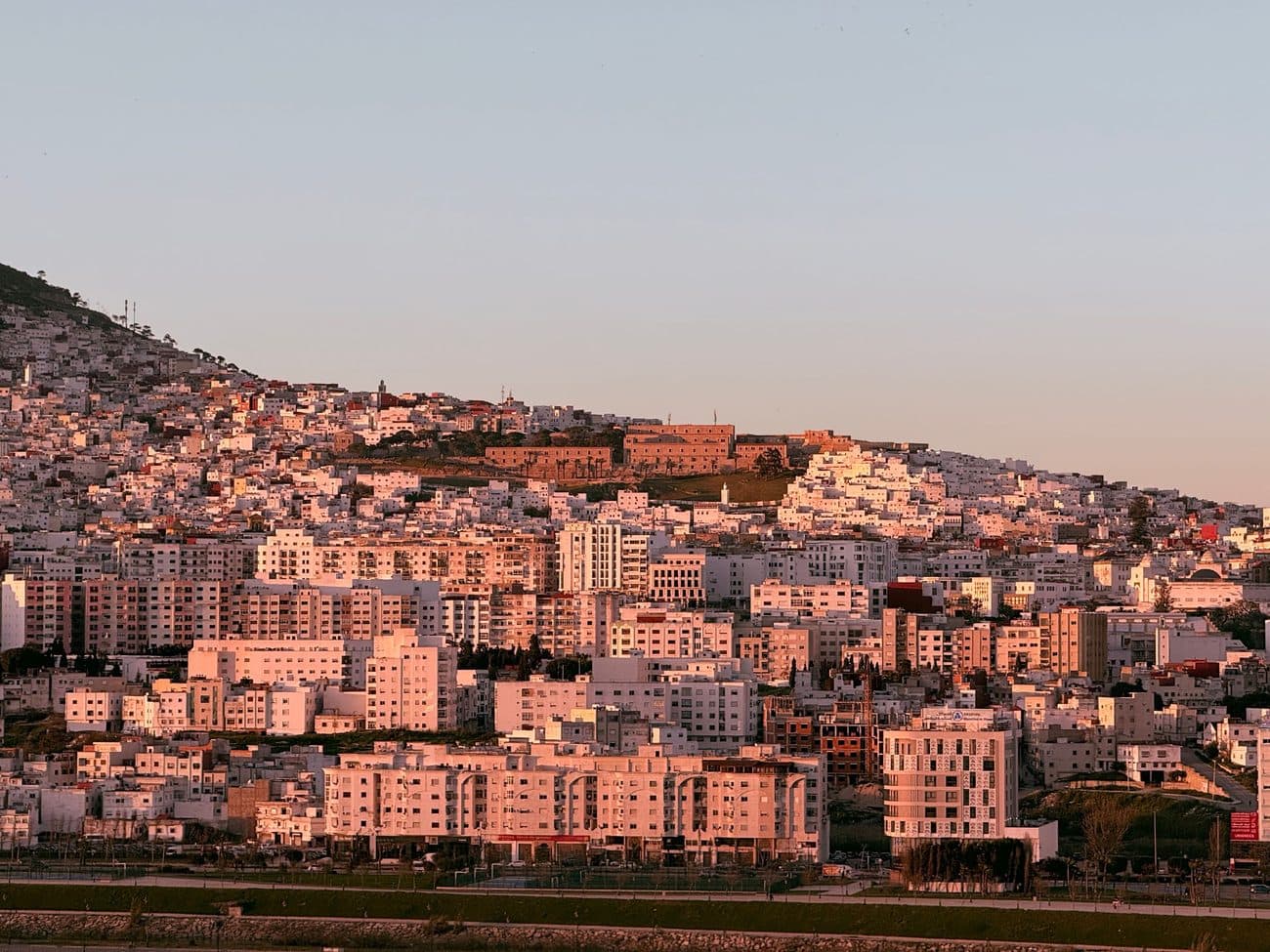 Tangier tiered across the hillside in pink sunset light