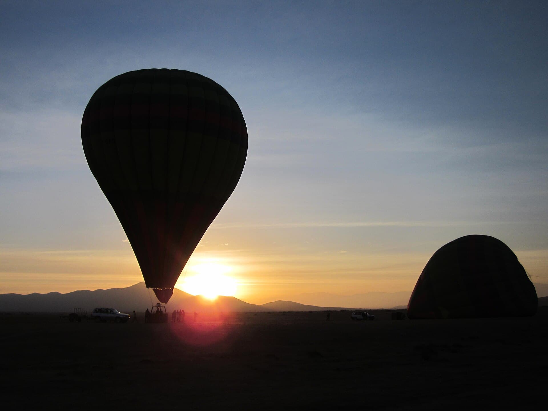 Hot-air balloon at sunrise over the Marrakech plain