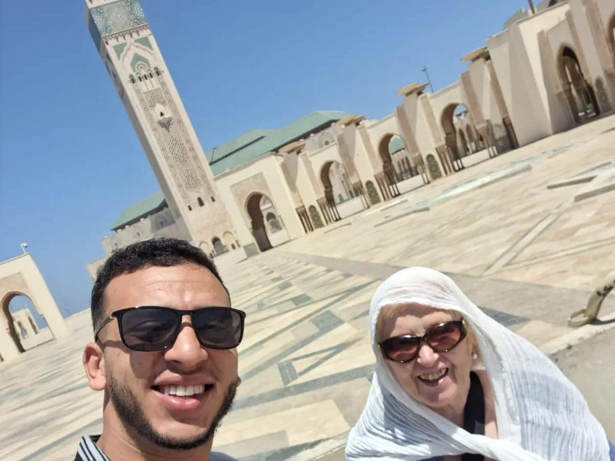A chauffeur and client on the esplanade of the Hassan II Mosque in Casablanca